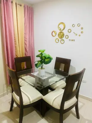 a glass table with two chairs and a potted plant at Apartamento Familiar 7 in Colorado