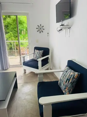 a living room with a couch and a tv at El patio de Lucia, center 4 people Las Terrenas in Las Terrenas