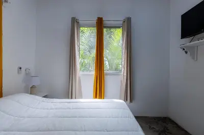 a bedroom with a bed and a window at El Patio de Lucia Residencia in Las Terrenas