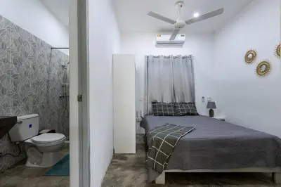 a bedroom with a bed and a ceiling fan at El Patio de Lucia Residencia in Las Terrenas
