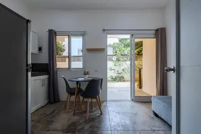 a kitchen and dining room with a table and chairs at El Patio de Lucia Residencia in Las Terrenas