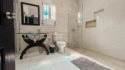 a bathroom with a sink and a toilet and a shower at Villa luxury Cabarete in Cabarete