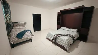 a bedroom with two beds and a large headboard at Villa luxury Cabarete in Cabarete
