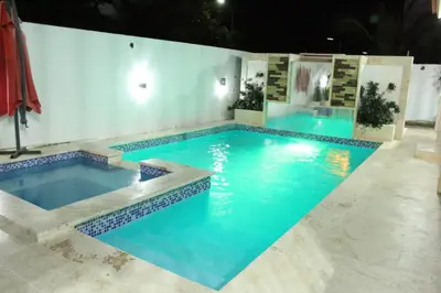 a swimming pool with blue water in a building at Villa luxury Cabarete in Cabarete