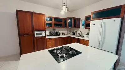 a kitchen with a stove and a white refrigerator at Villa luxury Cabarete in Cabarete