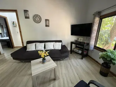 a living room with a couch and a table at Villa Jarabacoa Monte Bonito in Jarabacoa