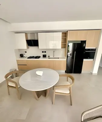 a kitchen and dining room with a white table and chairs at Aqua Esmeralda by Advantage Club in La Laguna