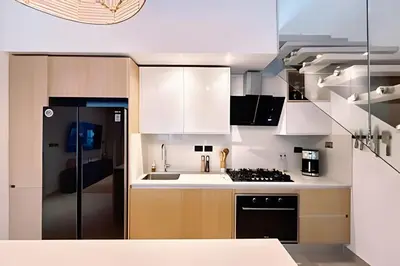 a kitchen with white cabinets and a stove at Aqua Esmeralda by Advantage Club in La Laguna