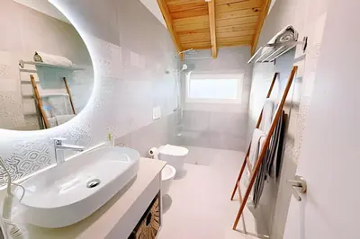 a bathroom with a white sink and a mirror at Aqua Esmeralda by Advantage Club in La Laguna