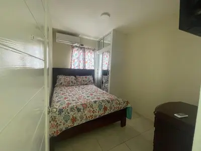 a small bedroom with a bed and a window at Furnished apartment available in La Romana