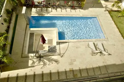 an overhead view of a swimming pool with two chairs at Best Friends Hoyo Cacao in Las Terrenas