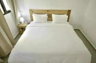 a large white bed with two pillows in a room at Best Friends Hoyo Cacao in Las Terrenas