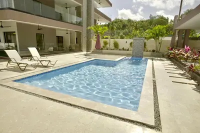 a swimming pool in front of a house at Best Friends Hoyo Cacao in Las Terrenas