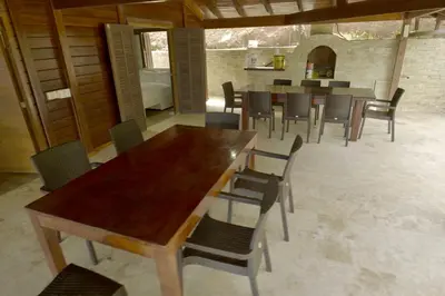 a dining room with a wooden table and chairs at Villa Jimi Las Terrenas in El Naranjito