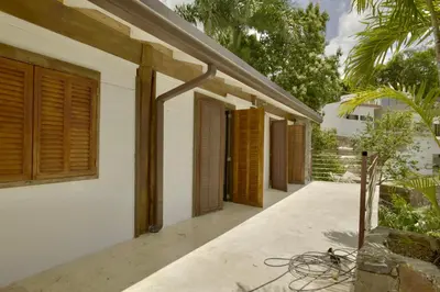 a house with wooden shutters on the side of it at Villa Lukner Las Terrenas in Las Terrenas