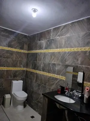 a bathroom with a toilet and a sink at Villa Magante in La Yagua