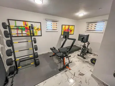 a fitness room with two treadmills and weights at Villa Paz in San Felipe de Puerto Plata