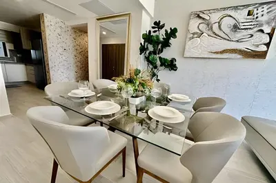 a dining room with a glass table and white chairs at Adult Only Luxe Retreat @ Coral Bay 2 in Punta Cana