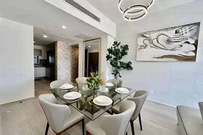a dining room with a glass table and white chairs at Adult Only Luxe Retreat @ Coral Bay 2 in Punta Cana