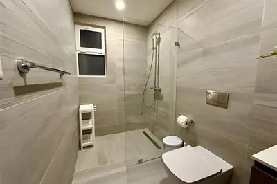 a bathroom with a shower and a toilet and a sink at Adult Only Luxe Retreat @ Coral Bay 2 in Punta Cana