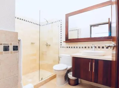 a bathroom with a toilet and a sink and a shower at Beachfront Luxury Penthouse in Sosúa