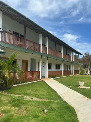 an exterior view of a building with a yard at Habitacion con Jacuzzy en Dani's Guest House in Las Galeras