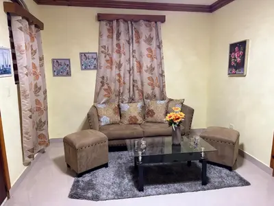 a living room with a couch and a table at Hotel El Bonao in Higuey