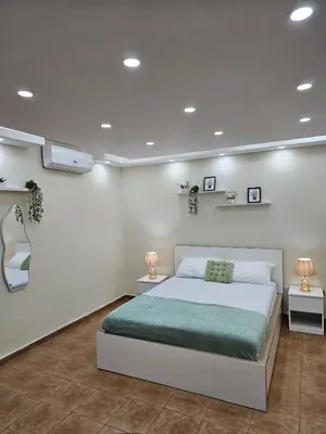 a bedroom with a bed and a mirror and lights at Jardines del Mar Todas las Amenidades Reserva Inmediata in Villas del Mar
