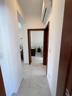 a hallway with a door and a tile floor at Blue apt H1 - two queen bedroom - POOL- in Sosúa