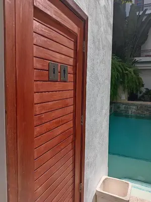 a wooden door to a house with a pool at Boutique Hotel Casa Grande, Parrot's Paradise Suite in Santo Domingo