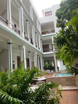 an external view of a building with plants at Boutique Hotel Casa Grande, Parrot's Paradise Suite in Santo Domingo