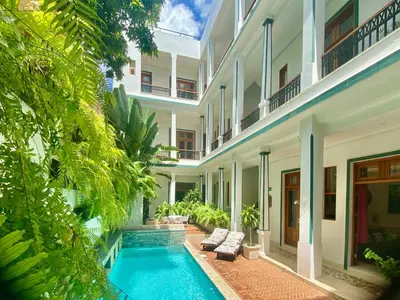 an exterior view of a building with a swimming pool at Boutique Hotel Casa Grande, Mango Tango Suite in Santo Domingo