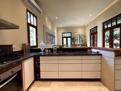 a large kitchen with black counter tops and windows at Luxury Two-Level Townhouse with Stunning Historic Views in Santo Domingo
