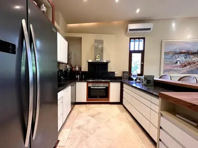 a large kitchen with a stainless steel refrigerator at Luxury Two-Level Townhouse with Stunning Historic Views in Santo Domingo