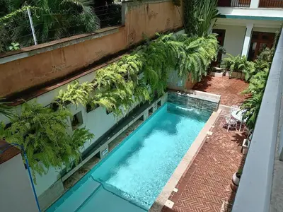 an overhead view of a swimming pool with palm trees around it at Boutique Hotel Casa Grande, Mandala Suite in Santo Domingo