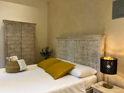 a bedroom with a white bed with a lamp and a headboard at Boutique Hotel Casa Grande, Banana Chica, Estudio superior con cocina in Santo Domingo