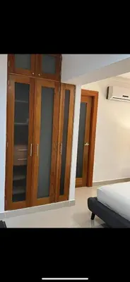 a bedroom with wooden cabinets and a bed at Luxury Apartment in Santo Domingo