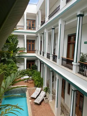 an external view of a hotel with a swimming pool at Boutique Hotel Casa Grande, Tropical Journey, Suite familiar de 2 dormitorios in Santo Domingo