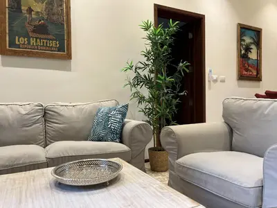 a living room with two couches and a table at Boutique Hotel Casa Grande, Tropical Journey, Suite familiar de 2 dormitorios in Santo Domingo