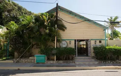 a small house with palm trees in front of it at Villas Jazmin in San Felipe de Puerto Plata