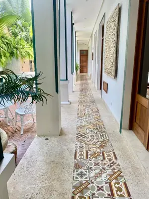 a hallway with tile flooring in a house at Boutique Hotel Casa Grande, Divas Suite in Santo Domingo