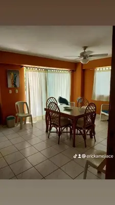 a dining room with a table and chairs at Edificio maremma 6 in Boca Chica