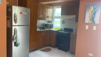 a kitchen with a white refrigerator and a microwave at Edificio maremma 6 in Boca Chica