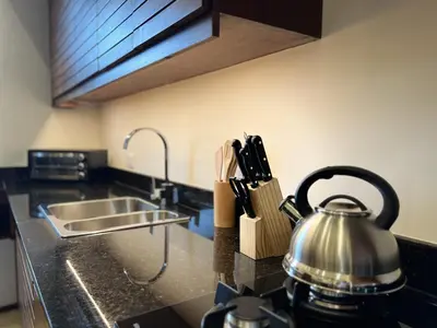 a kitchen counter with a tea kettle and a sink at Boutique Hotel Casa Grande, Dominican Voyage, Suite familiar de 2 dormitorios in Santo Domingo