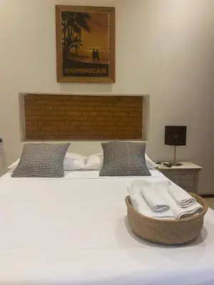 a bedroom with a bed with a towel on it at Boutique Hotel Casa Grande, Dominican Voyage, Suite familiar de 2 dormitorios in Santo Domingo