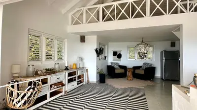 a kitchen with white walls and a black and white rug at Villa Blanca, Las Terrenas, 4 chambres in Las Terrenas