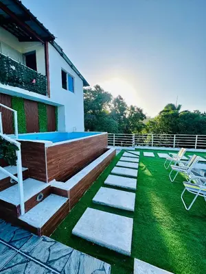 a backyard with a swimming pool and some chairs at Two levels Las Terrenas near to beaches in Las Terrenas