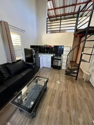 a living room with a couch and a glass table at Two levels Las Terrenas near to beaches in Las Terrenas