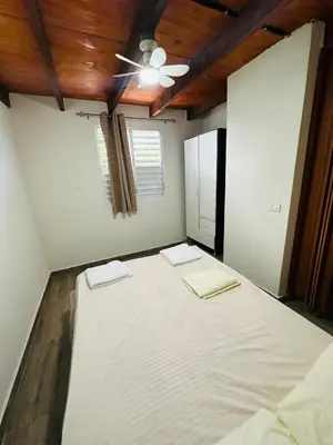 a large bed in a room with a ceiling at Two levels Las Terrenas near to beaches in Las Terrenas