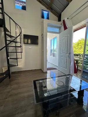 a room with a glass table and a staircase at Two levels Las Terrenas near to beaches in Las Terrenas